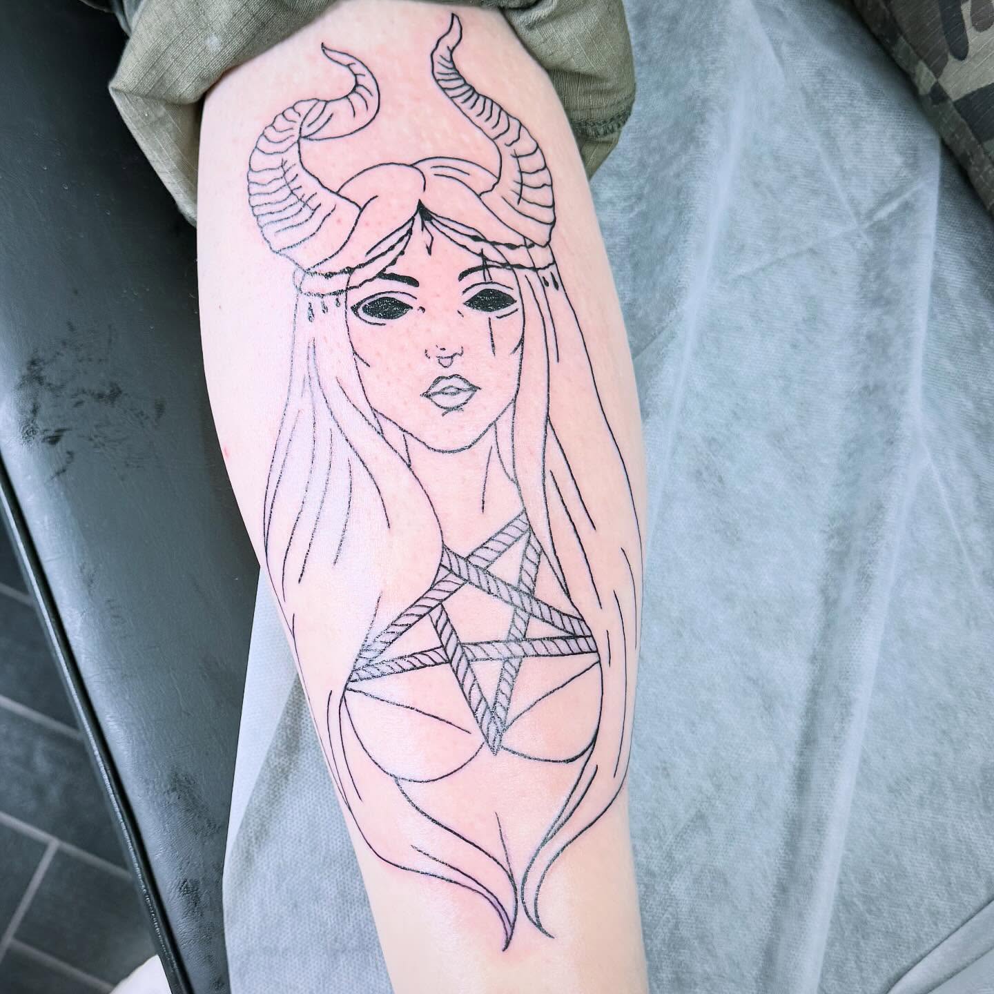A horned female figure with a pentagram, drawn in fine black linework
